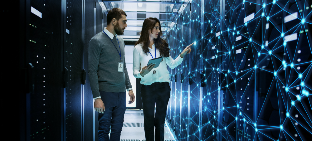 Technicians analyzing data servers in datacenter.